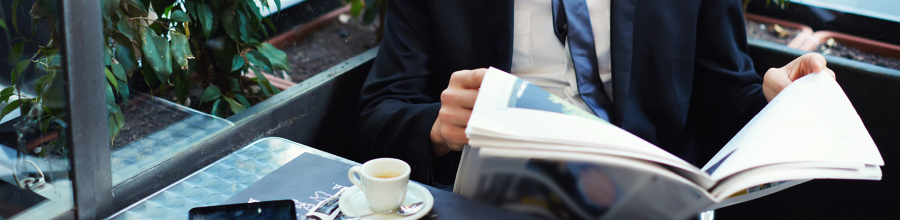 Man with paper drinking coffee